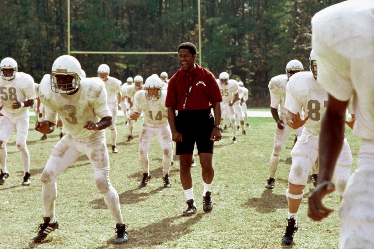 Coach Boone leading his players through conditioning in Remember the Titans.